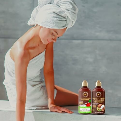 Woman in towel with coconut hair care products.