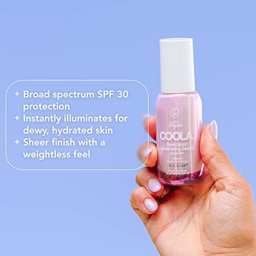 Hand holding Coola Dew Good Illuminating Serum with SPF 30 protection.