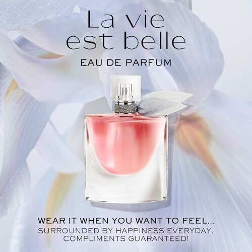 La Vie Est Belle perfume bottle with floral background.