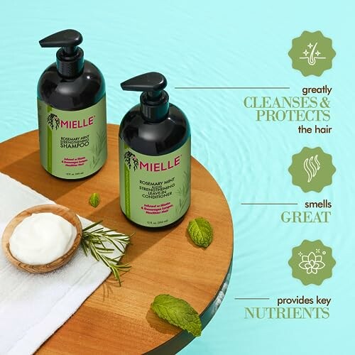 Mielle Rosemary Mint Shampoo and Conditioner on a wooden surface with benefits listed.