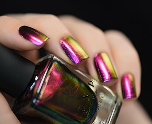 Hand with multicolor metallic nail polish holding a bottle.