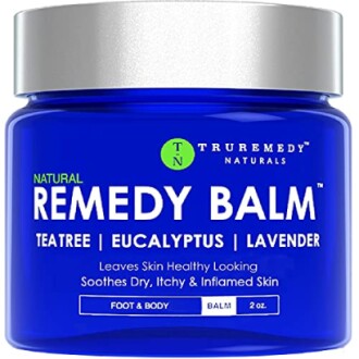 Blue jar of Natural Remedy Balm with tea tree, eucalyptus, and lavender for skin relief.