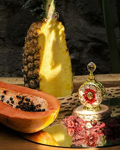 Ornate perfume bottle with floral design and artistic still life with sliced fruits.