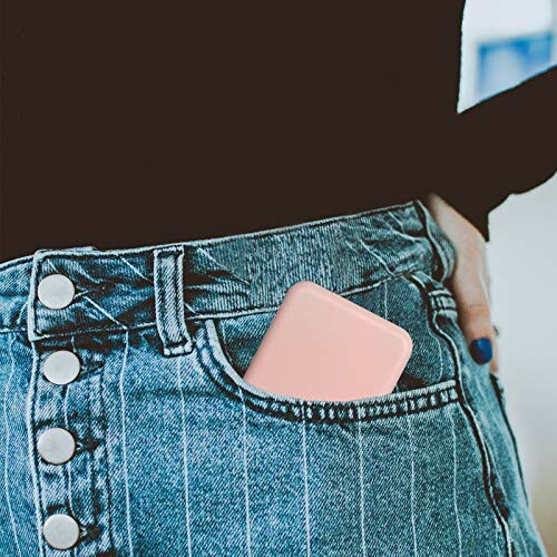 Person with a pink device in jeans pocket