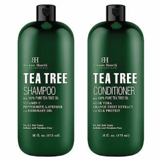 Botanic Hearth Tea Tree Shampoo and Conditioner bottles on a stylish bathroom shelf